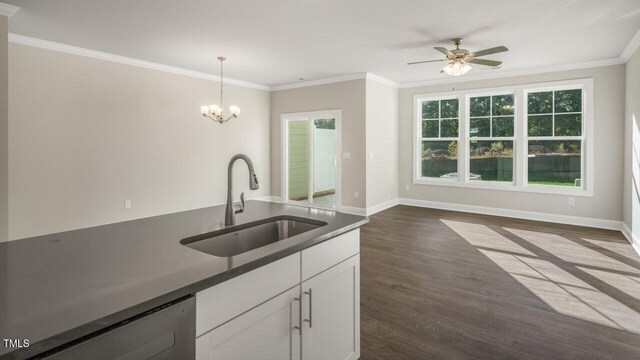 1825 Hinesley Dr, Durham, NC 27703 - kitchen with a sink, dark wood-type flooring, crown molding, dark countertops, and white cabinets