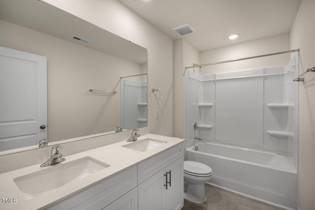 full bathroom featuring toilet, vanity, and tub / shower combination