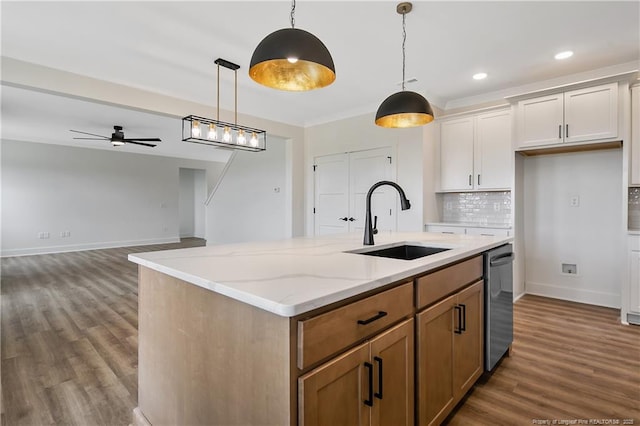 3727 Gainey Rd, Fayetteville, NC 28306 - kitchen featuring a sink, dishwasher, wood finished floors, a ceiling fan, and backsplash