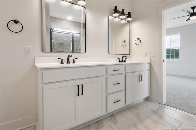 3727 Gainey Rd, Fayetteville, NC 28306 - full bathroom featuring baseboards, double vanity, a ceiling fan, marble look tile flooring, and an enclosed shower