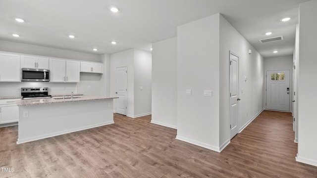 kitchen featuring white cabinetry, a kitchen island with sink, and appliances with stainless steel finishes