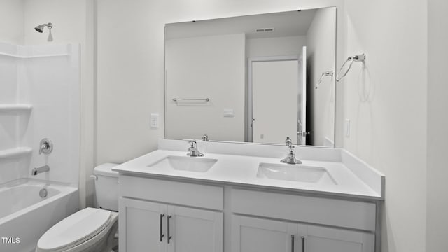 full bathroom featuring toilet, vanity, and washtub / shower combination