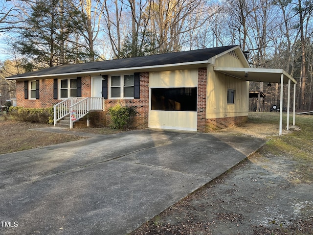 ranch-style home featuring a garage and a carport