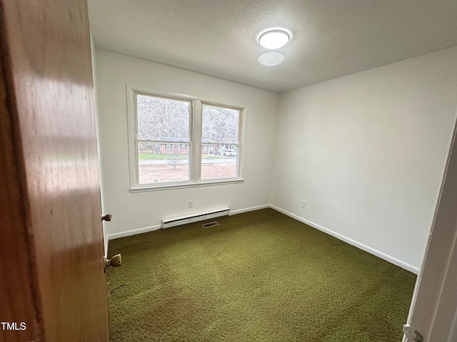 spare room with carpet flooring, a textured ceiling, and baseboard heating