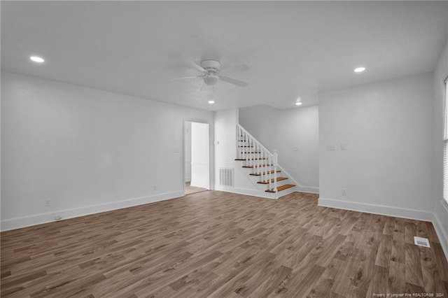 unfurnished living room featuring ceiling fan and wood-type flooring