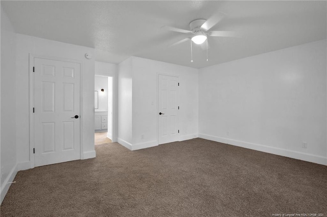 unfurnished bedroom with ceiling fan, a closet, and dark carpet