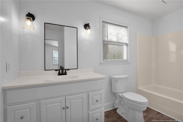 full bathroom featuring hardwood / wood-style floors, vanity, shower / bathtub combination, and toilet