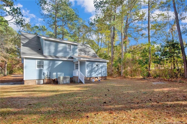 back of property featuring a lawn and central AC unit