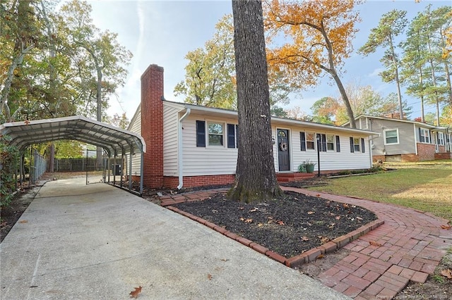 view of front facade with a front yard and a carport