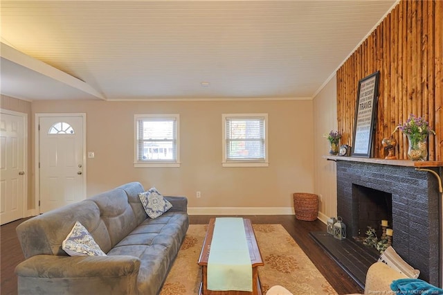 living room featuring crown molding, dark hardwood / wood-style flooring, and wood walls