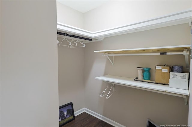 walk in closet featuring dark hardwood / wood-style floors