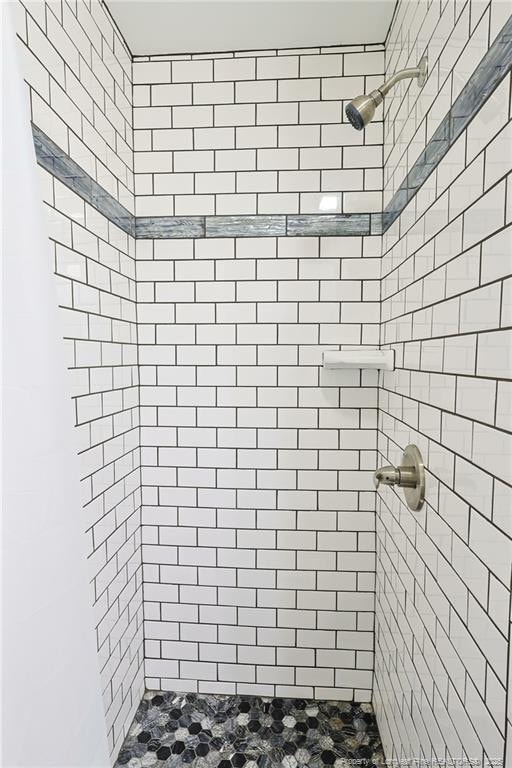 bathroom with a tile shower