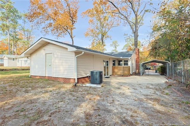 view of property exterior with central AC and a carport