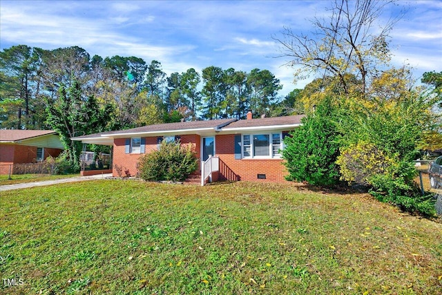 ranch-style house with a front lawn and a carport