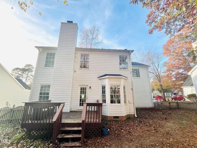 rear view of house featuring a wooden deck