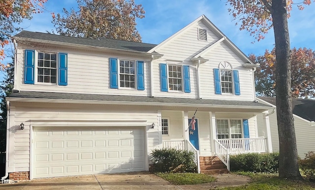 view of front property featuring a porch and a garage