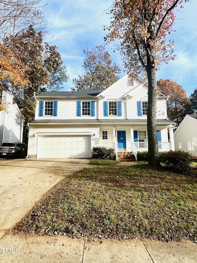 view of property with a garage and covered porch