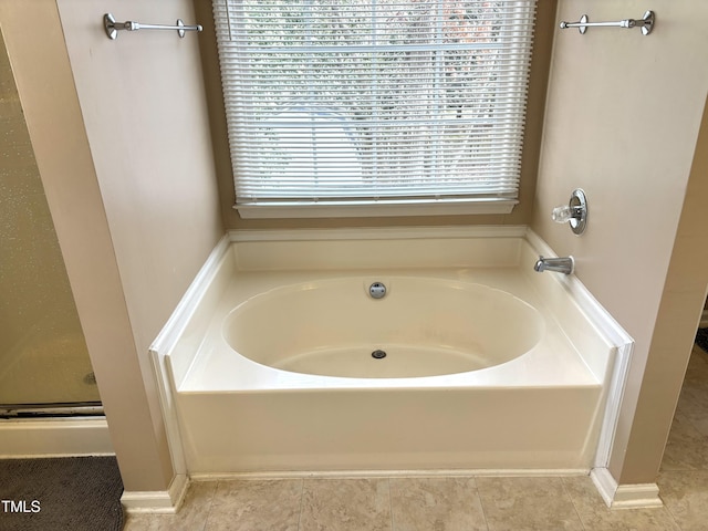 bathroom with a wealth of natural light, tile patterned floors, and independent shower and bath