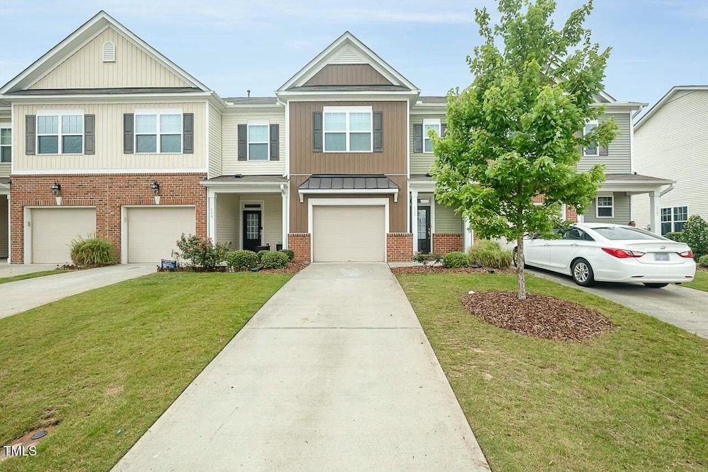 multi unit property featuring a front yard and a garage