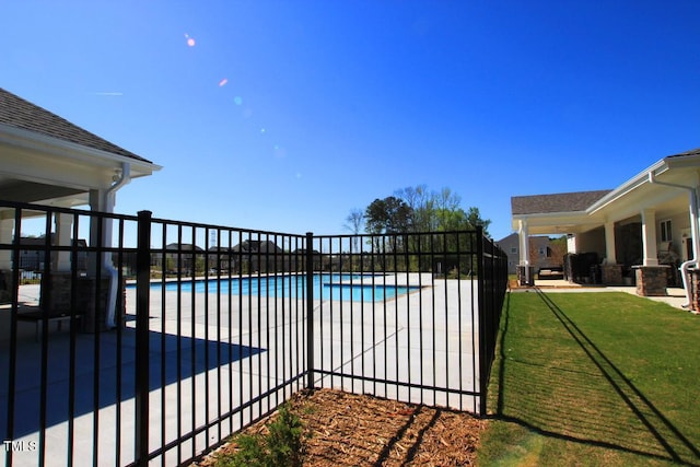 view of pool with a lawn and a patio area