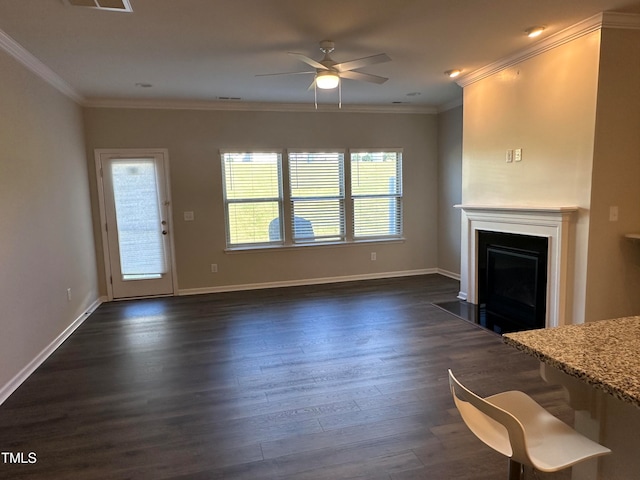 unfurnished living room featuring dark hardwood / wood-style floors, ceiling fan, and ornamental molding