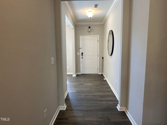 hallway with dark hardwood / wood-style floors and ornamental molding