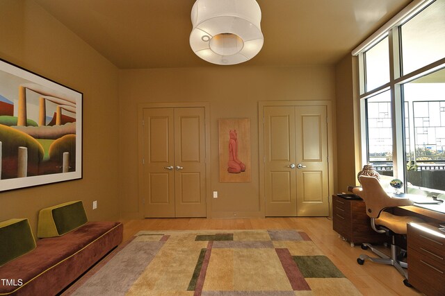 home office with light hardwood / wood-style flooring