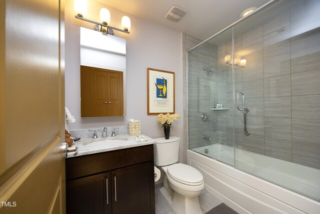 full bathroom with tile patterned floors, vanity, toilet, and combined bath / shower with glass door