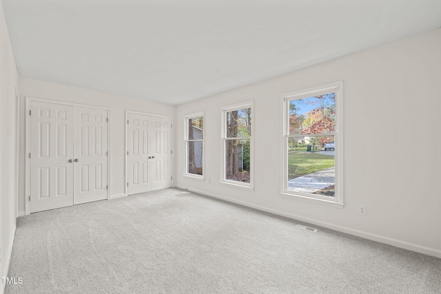 empty room featuring light carpet