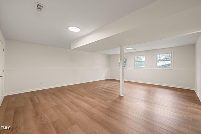 basement with light hardwood / wood-style floors