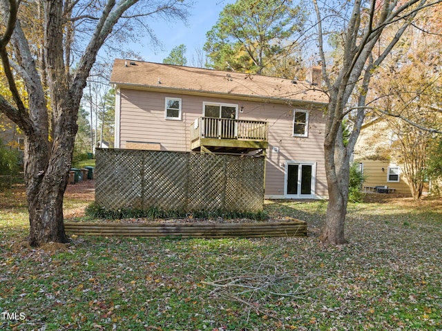 back of house featuring a wooden deck