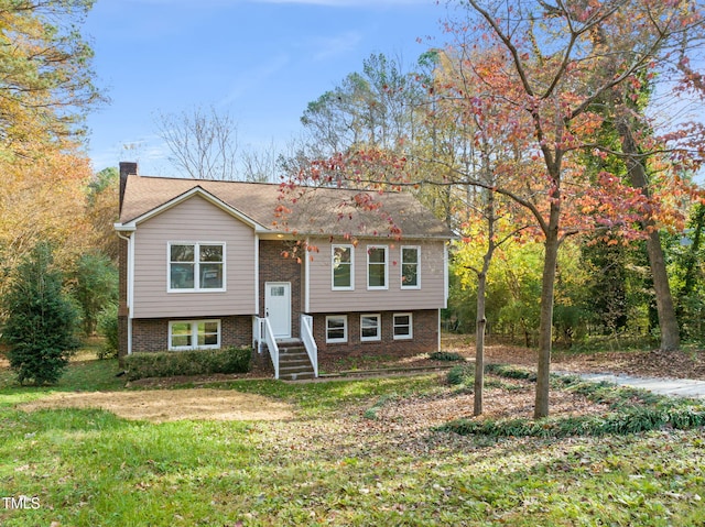 bi-level home with a front lawn