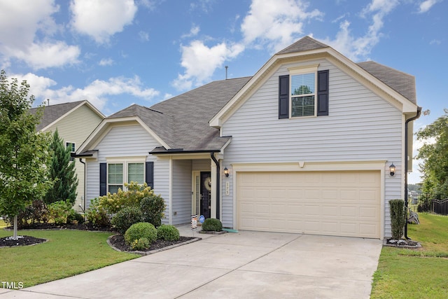 view of property with a front lawn and a garage