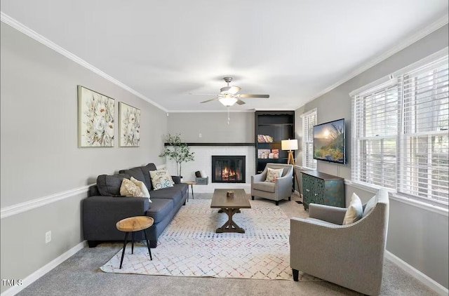 carpeted living room featuring crown molding and ceiling fan