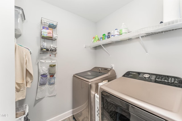 clothes washing area with washing machine and dryer