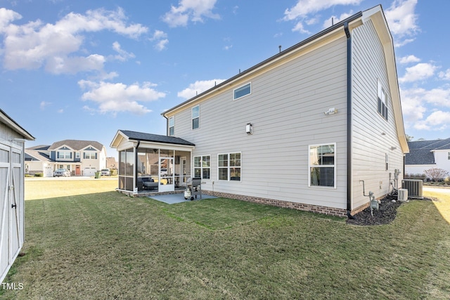 back of property with a sunroom, cooling unit, a yard, and a patio