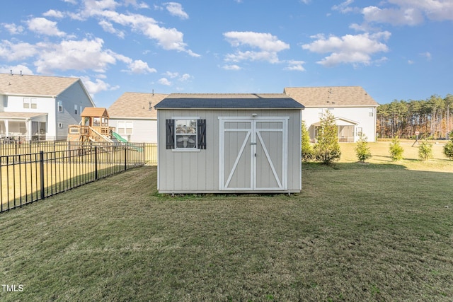 view of outdoor structure with a playground and a lawn