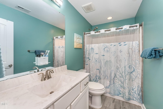 bathroom with a shower with shower curtain, vanity, hardwood / wood-style flooring, and toilet