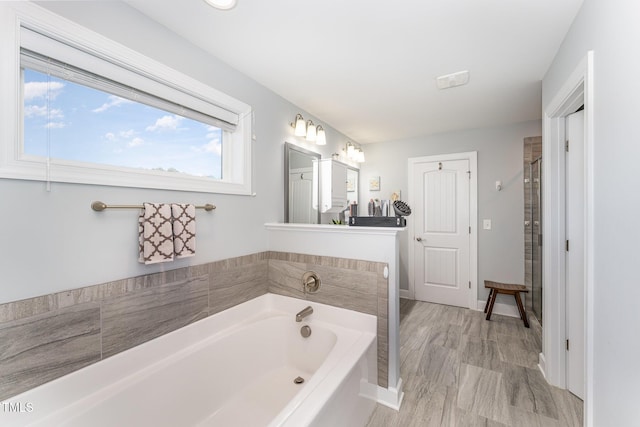 bathroom featuring vanity, hardwood / wood-style floors, and plus walk in shower