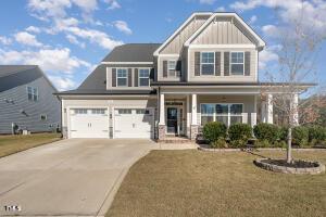 craftsman-style house with a front yard and a garage