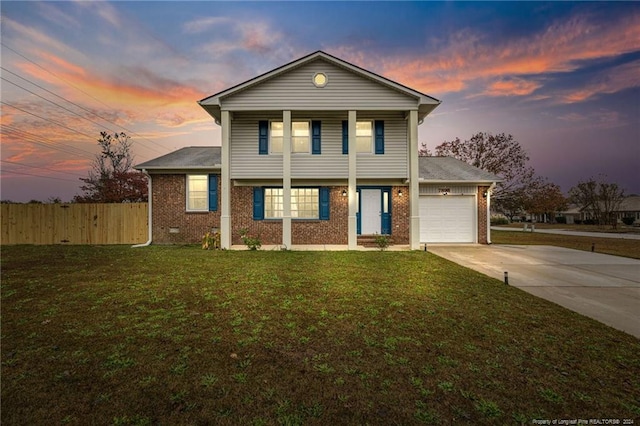 view of front of house featuring a garage and a lawn