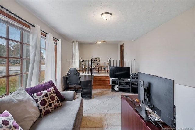 tiled living room featuring a textured ceiling and ceiling fan