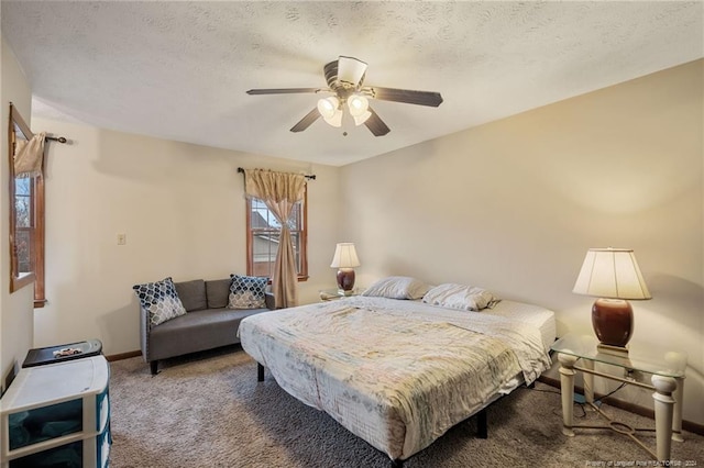 carpeted bedroom with ceiling fan and a textured ceiling