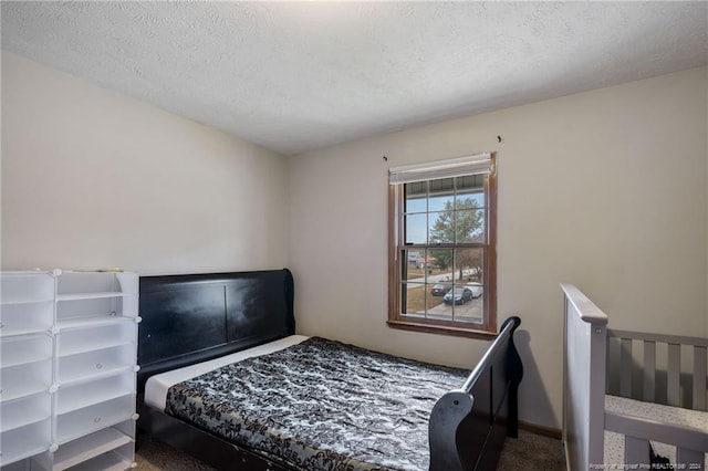 carpeted bedroom featuring a textured ceiling