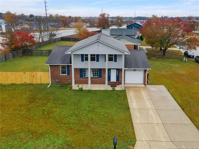 view of front of home with a front yard and a garage