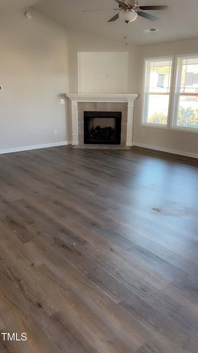 unfurnished living room with dark hardwood / wood-style floors, ceiling fan, and a fireplace