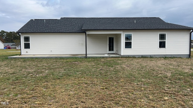 rear view of house with a yard and a patio