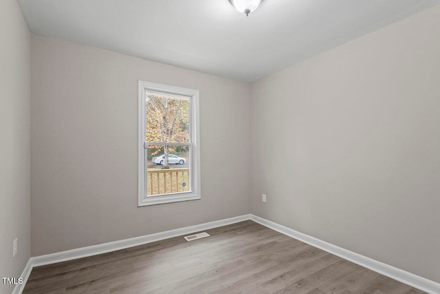 spare room with hardwood / wood-style flooring