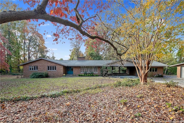 ranch-style house featuring a front yard and a carport