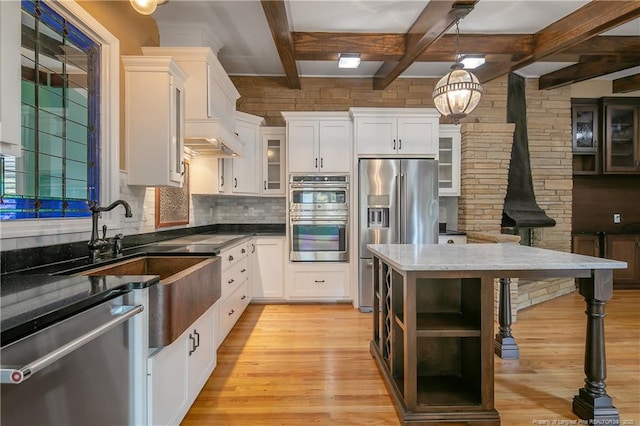 kitchen with beamed ceiling, decorative light fixtures, white cabinetry, and stainless steel appliances